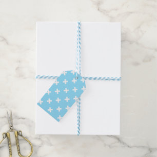 White cross stitches on baby blue gift tags