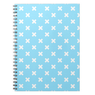 White cross stitches on baby blue notebook