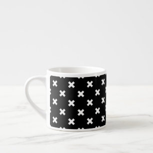 White cross stitches on black espresso cup