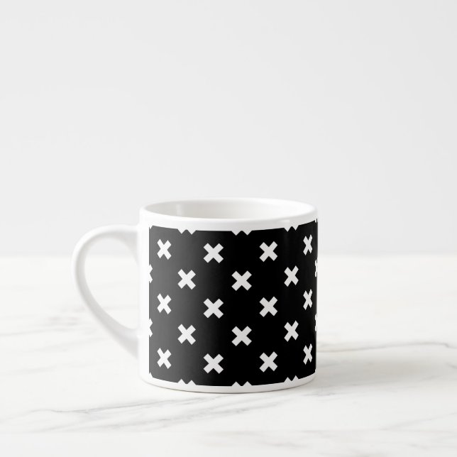 White cross stitches on black espresso cup (Left)