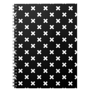 White cross stitches on black notebook