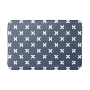 White cross stitches on blue-grey bath mat