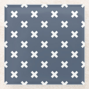 White cross stitches on blue-grey glass coaster