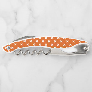 White cross stitches on burnt orange corkscrew