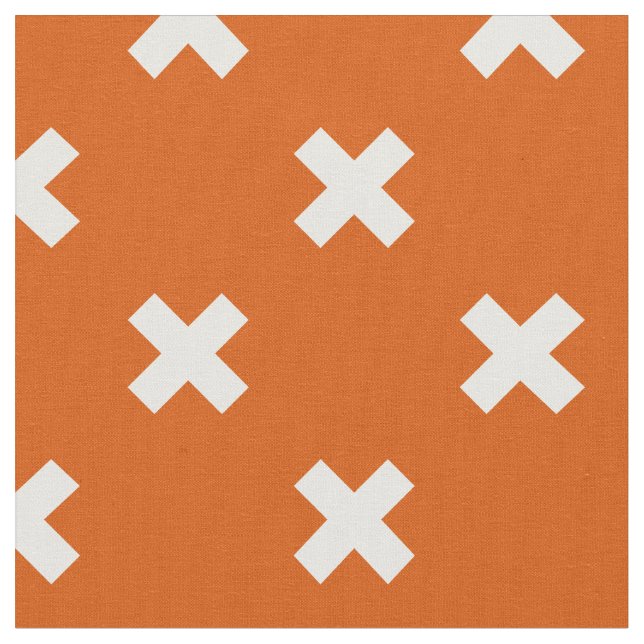 White cross stitches on burnt orange fabric (Close Up)