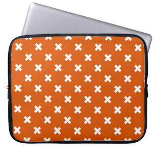 White cross stitches on burnt orange laptop sleeve