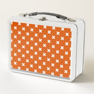 White cross stitches on burnt orange metal lunch box