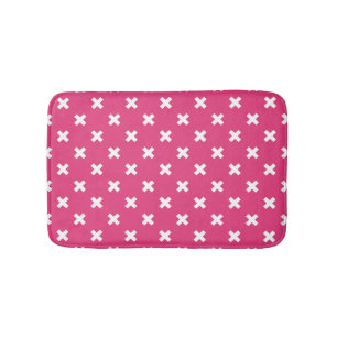 White cross stitches on fuchsia bath mat