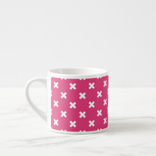 White cross stitches on fuchsia espresso cup