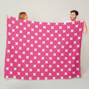 White cross stitches on fuchsia fleece blanket