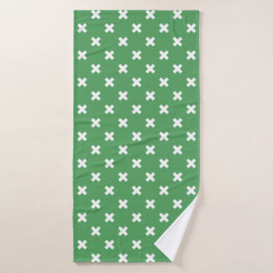 White cross stitches on green bath towel