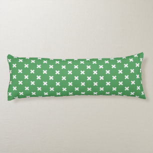 White cross stitches on green body cushion