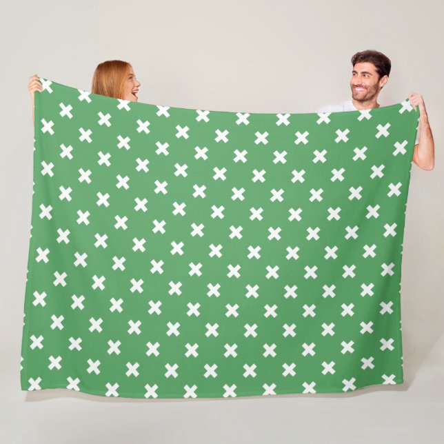 White cross stitches on green fleece blanket (In Situ)