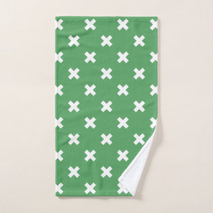 White cross stitches on green hand towel