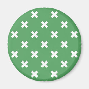 White cross stitches on green magnet