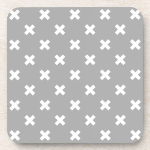 White cross stitches on grey coaster