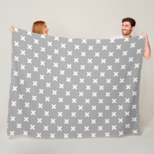White cross stitches on grey fleece blanket