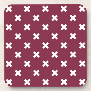 White cross stitches on mulberry coaster