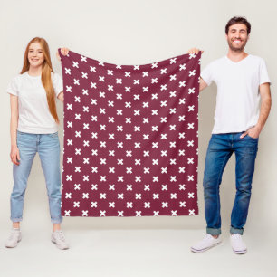 White cross stitches on mulberry fleece blanket