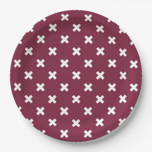 White cross stitches on mulberry paper plate