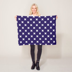 White cross stitches on navy blue fleece blanket