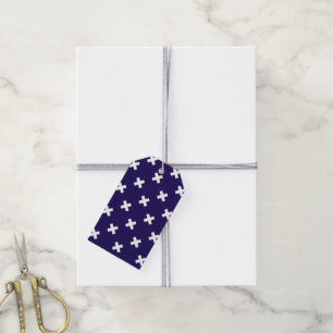 White cross stitches on navy blue gift tags