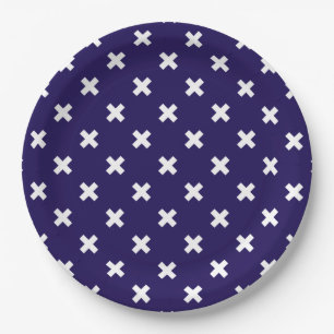 White cross stitches on navy blue paper plate