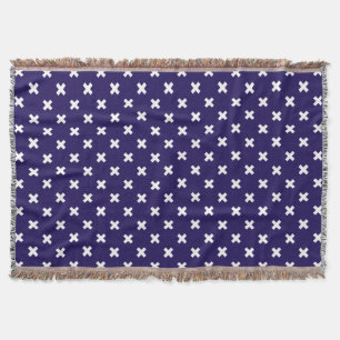 White cross stitches on navy blue throw blanket