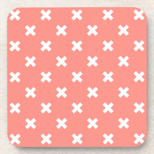 White cross stitches on peach coaster