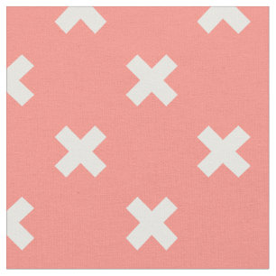 White cross stitches on peach fabric