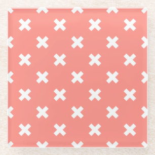 White cross stitches on peach glass coaster