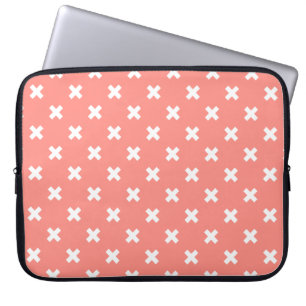 White cross stitches on peach laptop sleeve