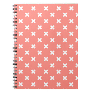 White cross stitches on peach notebook