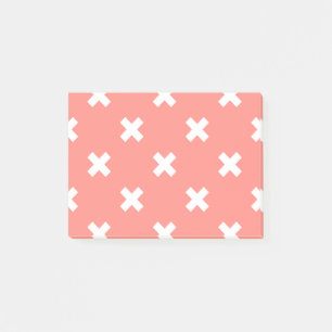 White cross stitches on peach post-it notes