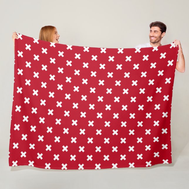 White cross stitches on red fleece blanket (In Situ)
