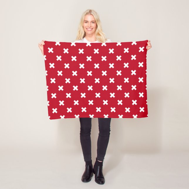 White cross stitches on red fleece blanket (In Situ)