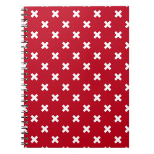 White cross stitches on red notebook