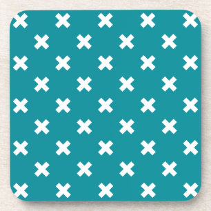 White cross stitches on teal coaster
