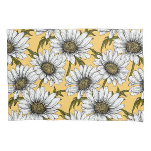 White daisies, wild flowers on yellow pillowcase