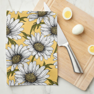 White daisies, wild flowers on yellow tea towel