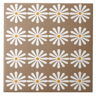 White daisies with yellow centres on sorrell brown tile