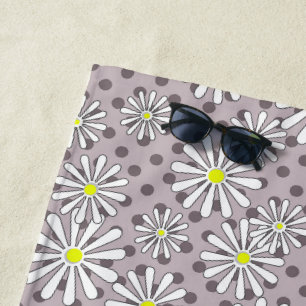 White daisy flowers on a beige brown polka dot beach towel
