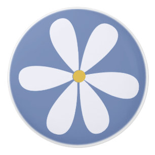 White daisy with yellow centre on mid blue back ceramic knob