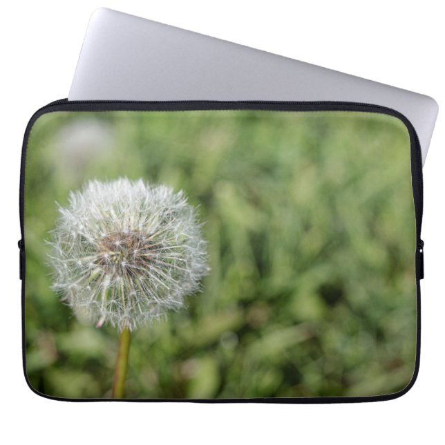 White dandelion flower on green grass laptop sleeve (Front)