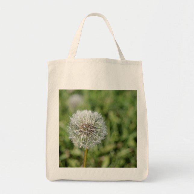 White dandelion flower on green grass tote bag (Front)