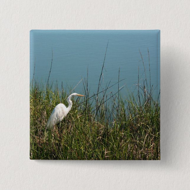 White egret standing in grass w water 15 cm square badge (Front)