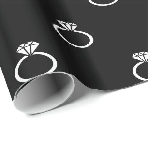 White Engagement Rings on Black Wrapping Paper