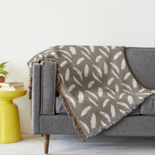 White feather print on taupe throw blanket