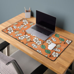 White Floral Design on Orange Desk Mat