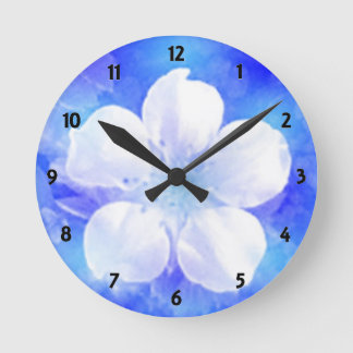 White flower on a blue background Wall Clock